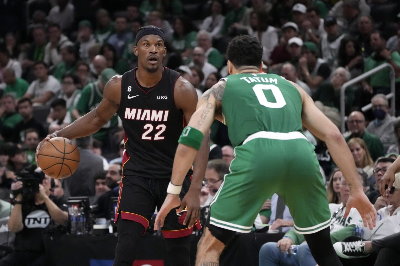 Miami Heat forward Jimmy Butler dribbles against Boston Celtics forward Jayson Tatum in second half of Game 7 of NBA Eastern Conference finals, May 29, 2023