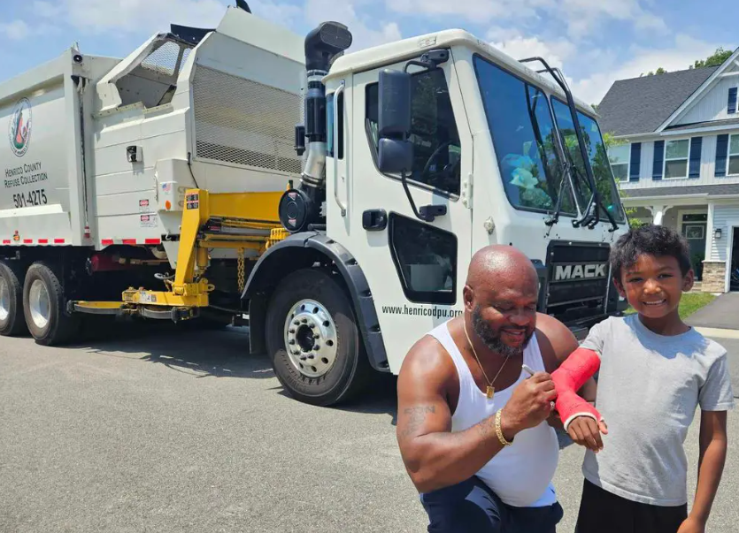 Henrico DPU employee Ronnie Miles signs the cast of Henrico youngster JB.