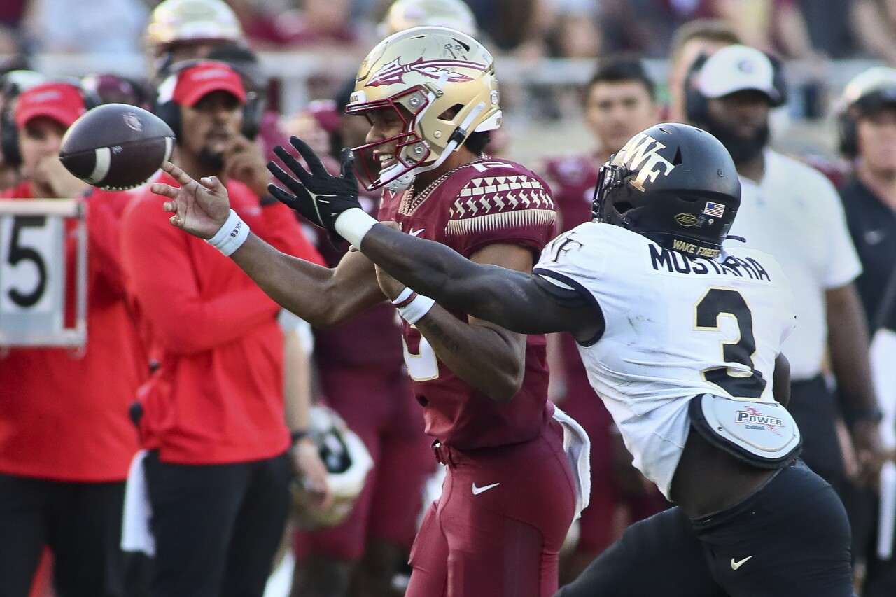Florida State Seminoles QB Jordan Travis pressured by Wake Forest Demon Deacons defensive back Malik Mustapha, Oct. 1, 2022