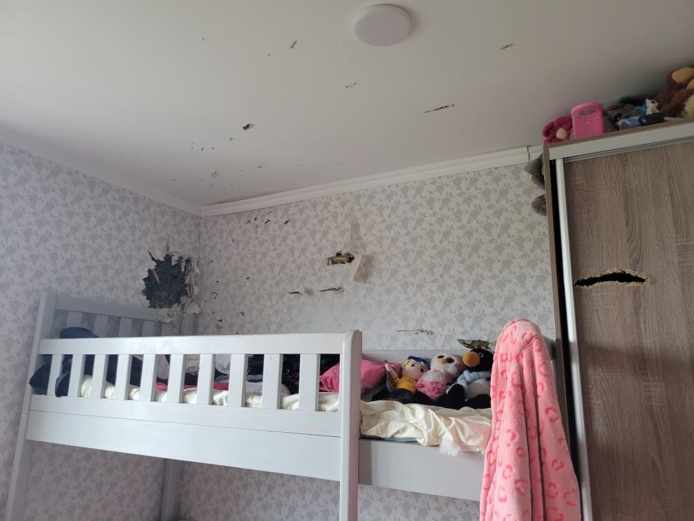 Damage from gunfire in bedroom in Ukrainian foster home