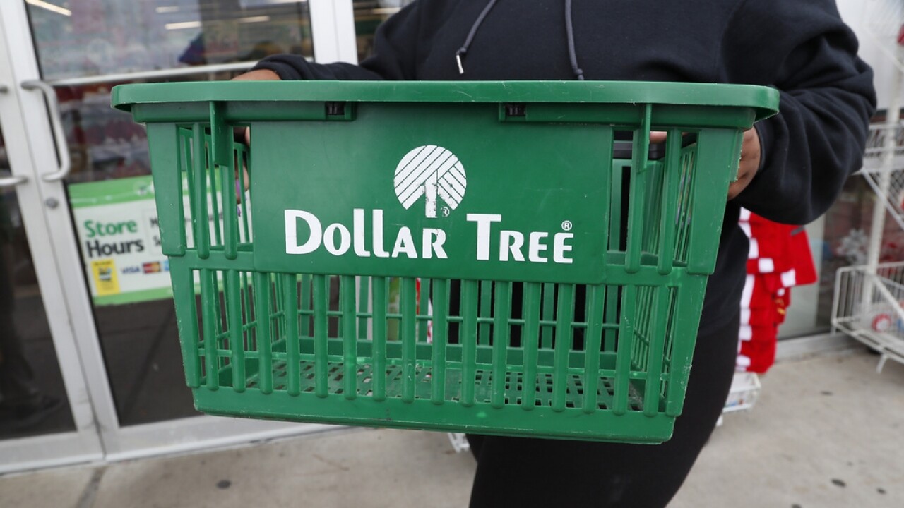 A clerk brings in a shopping basket at a Dollar Tree store