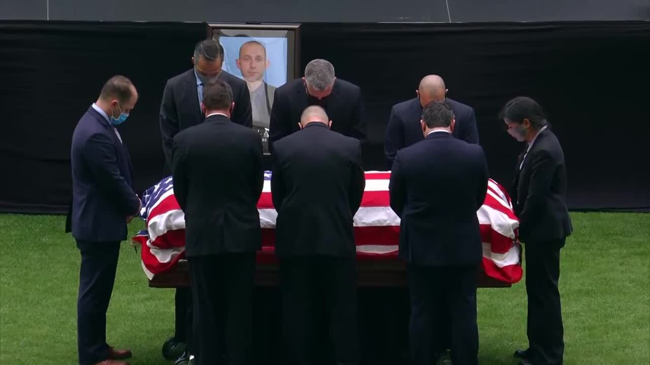 Pallbearers bow their heads while standing around casket of Daniel Alfin during memorial service at Hard Rock Stadium, Feb. 7, 2021
