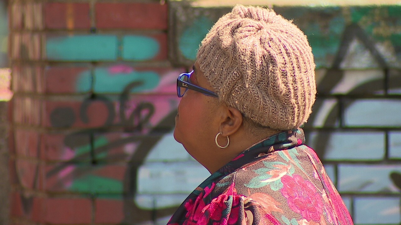 LaRhon Wheeler looks up at a crumbling former Westinghouse Electric complex in Cleveland's Central neighborhood. She can't wait for the building to be demolished.