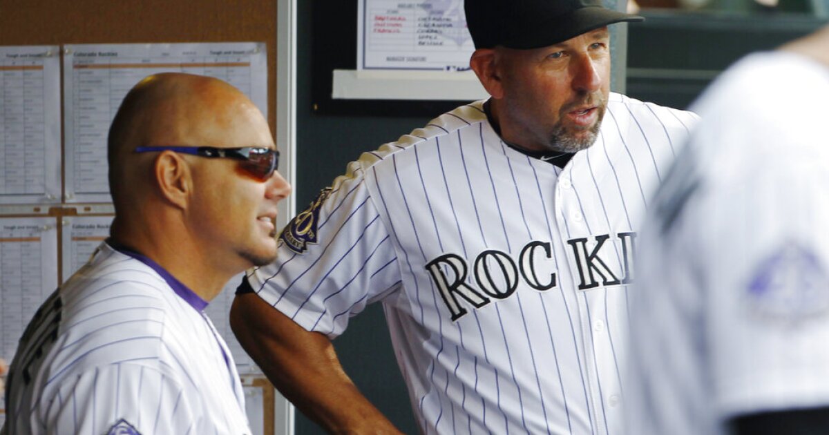 Dante Bichette of the Colorado Rockies looking on holding a bat