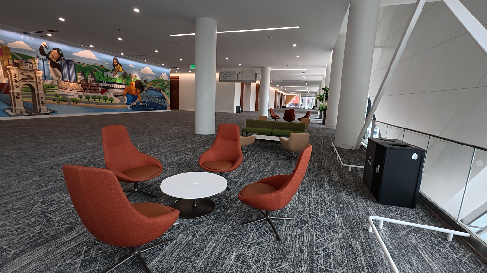 A seating area in the newly renovated First Financial Center, with a local mural in the background.