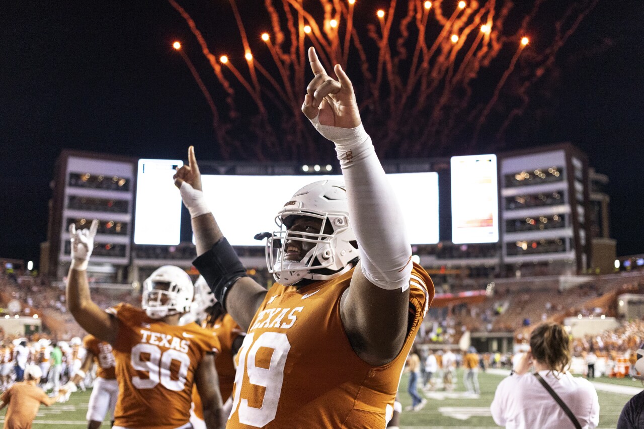 Texas Longhorns defensive linemen Keondre Coburn and Byron Murphy II celebrate win against West Virginia Mountaineers, Oct. 1, 2022