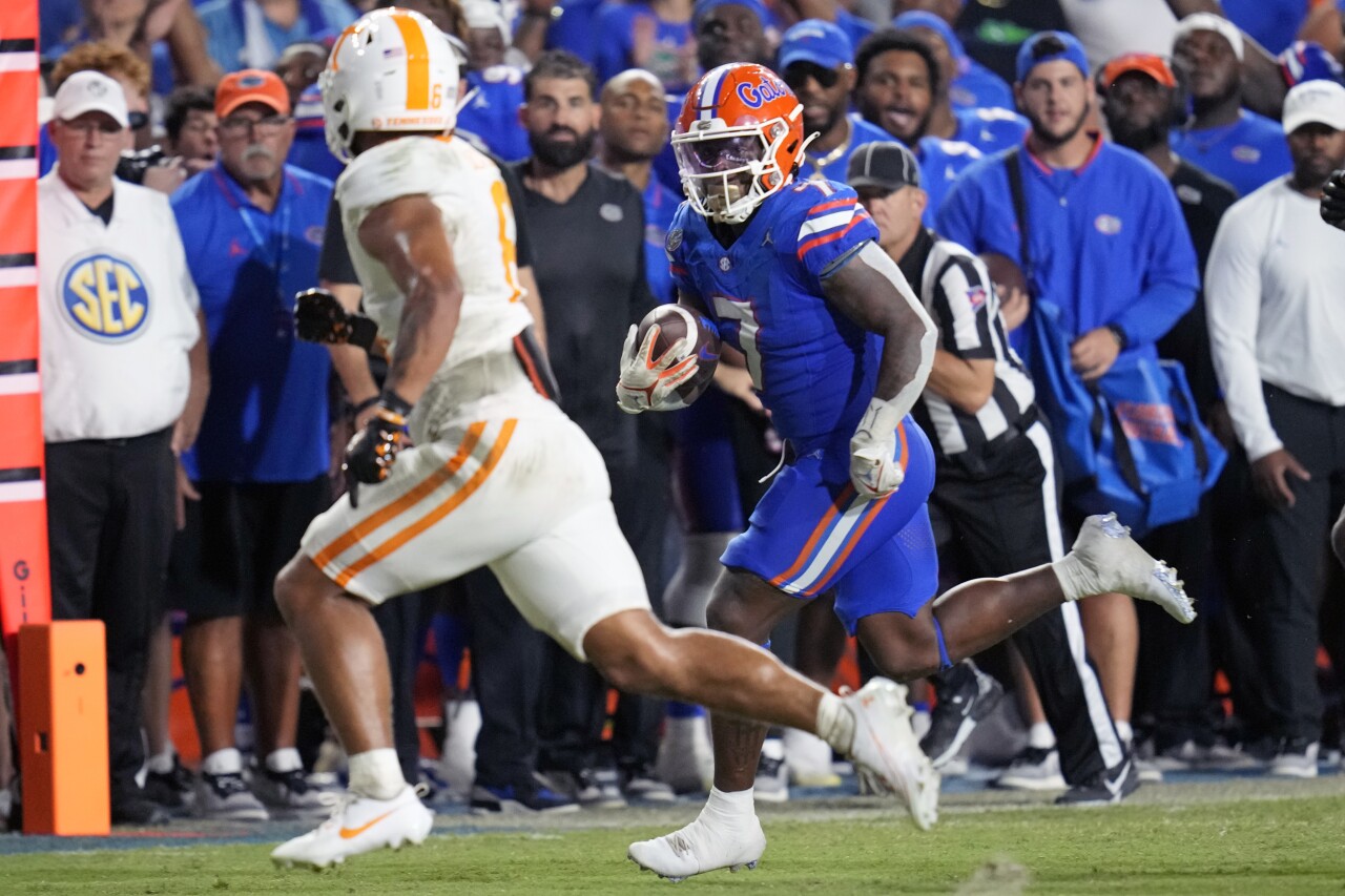 Florida Gators running back Trevor Etienne tries to get past Tennessee Volunteers linebacker Aaron Beasley, Sept. 16, 2023