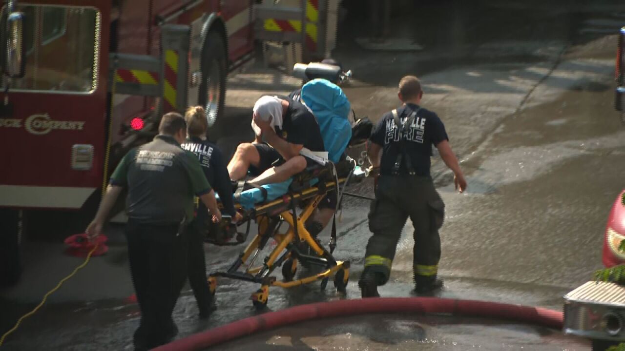 man on stretcher in record heat firefighting apartment fire