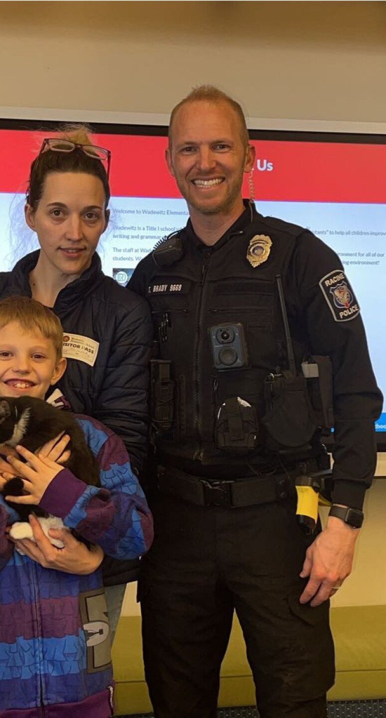 Austyn with his mom, RPD Officer Travis Brady and his new kitten 