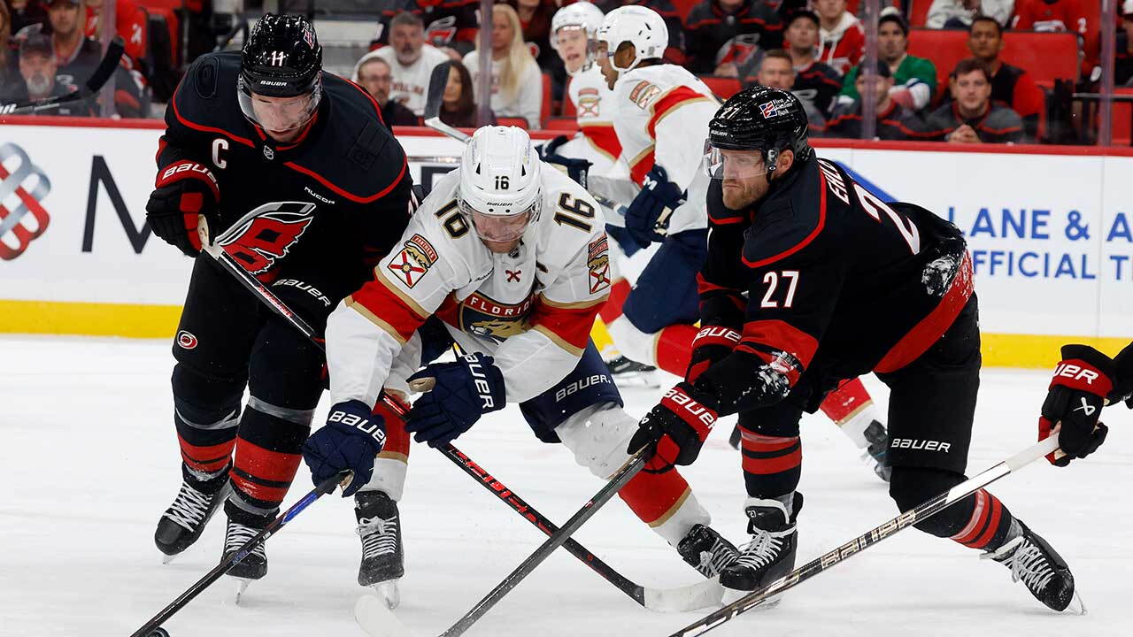 Florida Panthers' Aleksander Barkov (16) battles for the puck between Carolina Hurricanes' Jordan Staal, left, and Nikolaj Ehlers (27) during the third period of an NHL hockey game in Raleigh, N.C., Tuesday, Sept. 29, 2026.