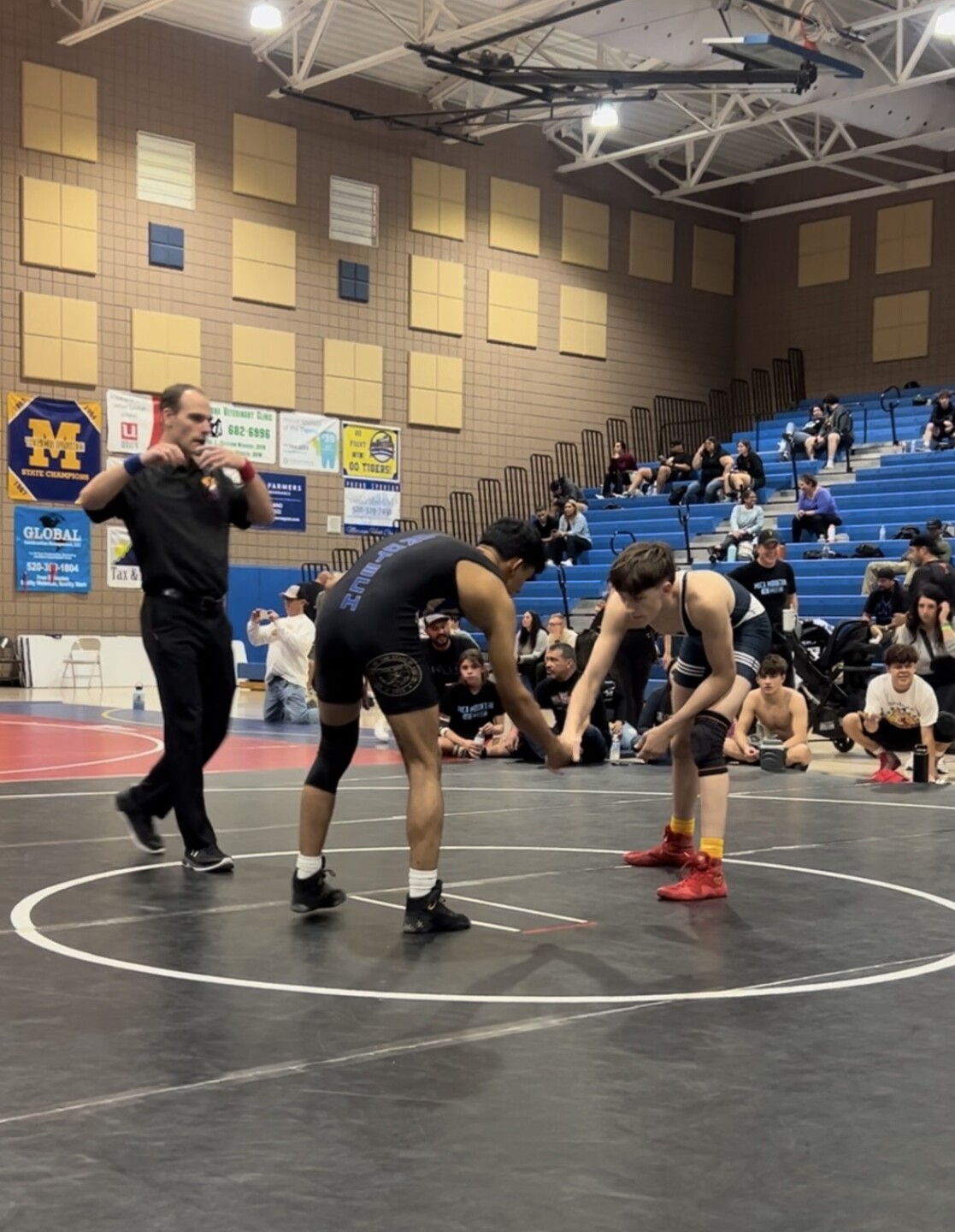 19-year-old Minhaj Jamshidi, left, competes in a wrestling tournament