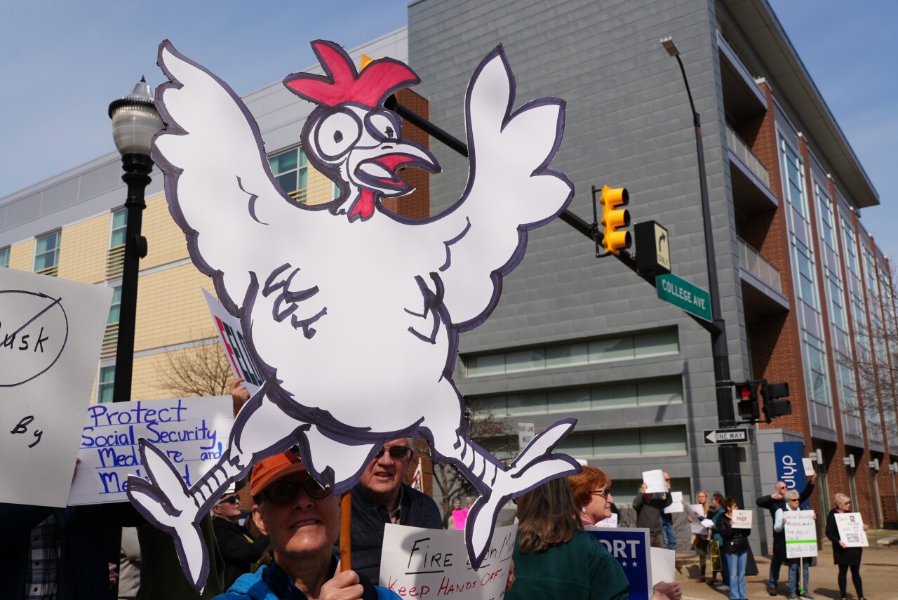 Protest outside of Rep. Bill Huizenga's office in Holland