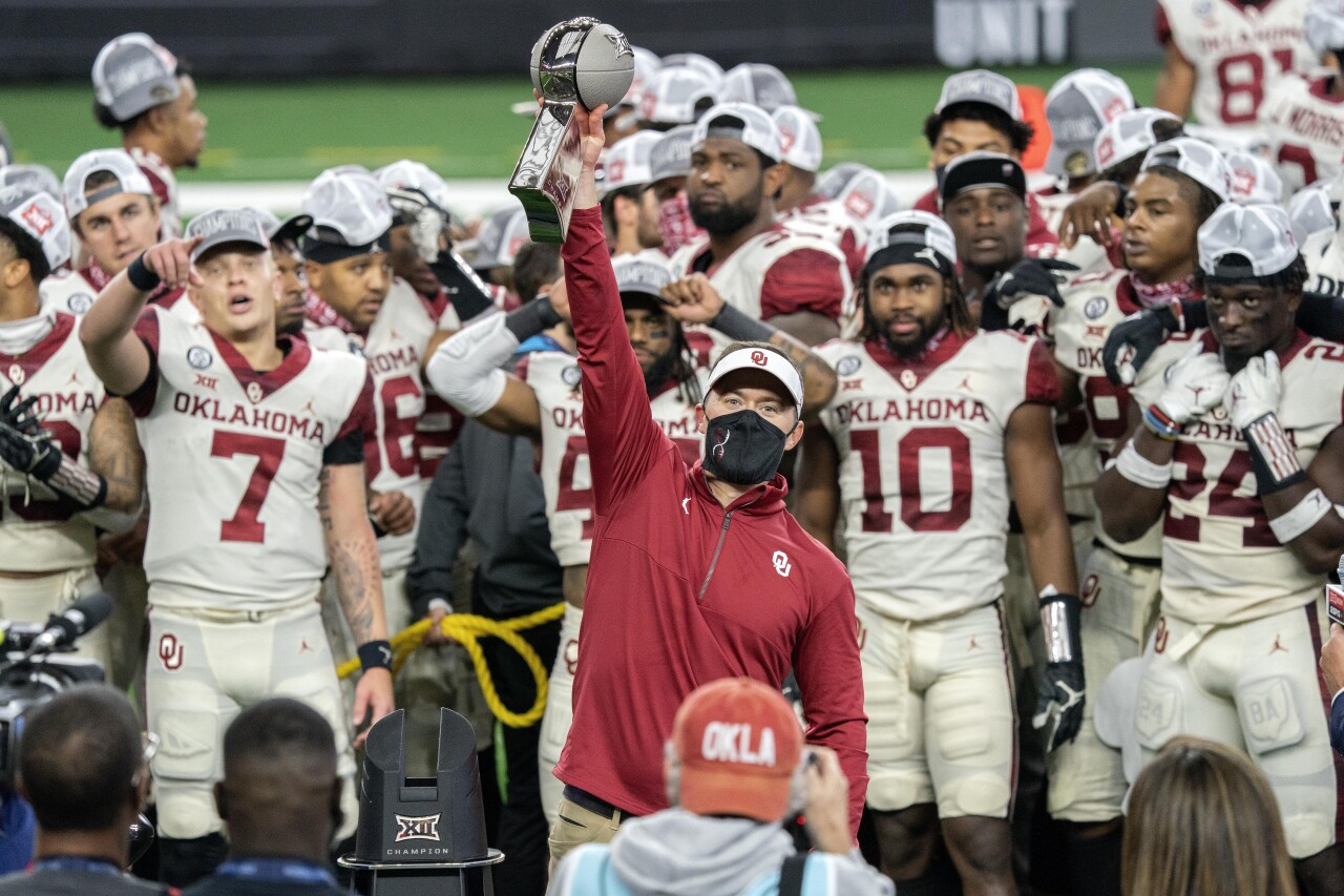 Oklahoma Sooners head coach Lincoln Riley hoists 2020 Big 12 Conference trophy