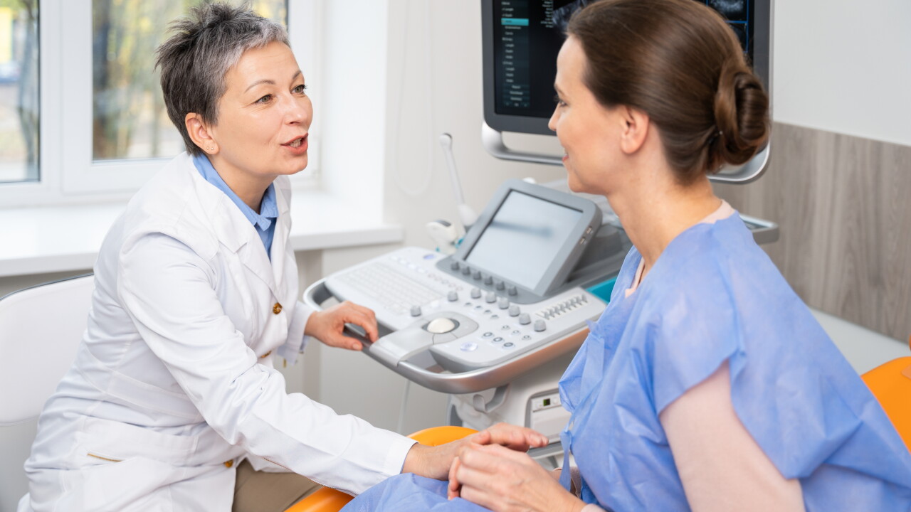 A,Doctor,And,Patient,Converse,During,An,Ultrasound,Appointment,,With