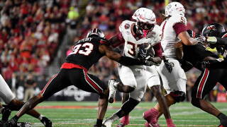 Florida State running back Ousmane Kromah (32) attempts to get past Louisville linebacker Ben Perry (23) during the first half of an NCAA college football game in Louisville, Ky., Friday, Oct. 9, 2026. (AP Photo/Timothy D. Easley)