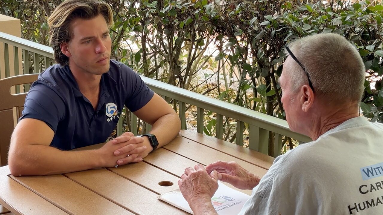 WPTV reporter Tyler Hatfield speaks to a member of the community at a Let's Hear It event in Port St. Lucie on Feb. 18, 2026.