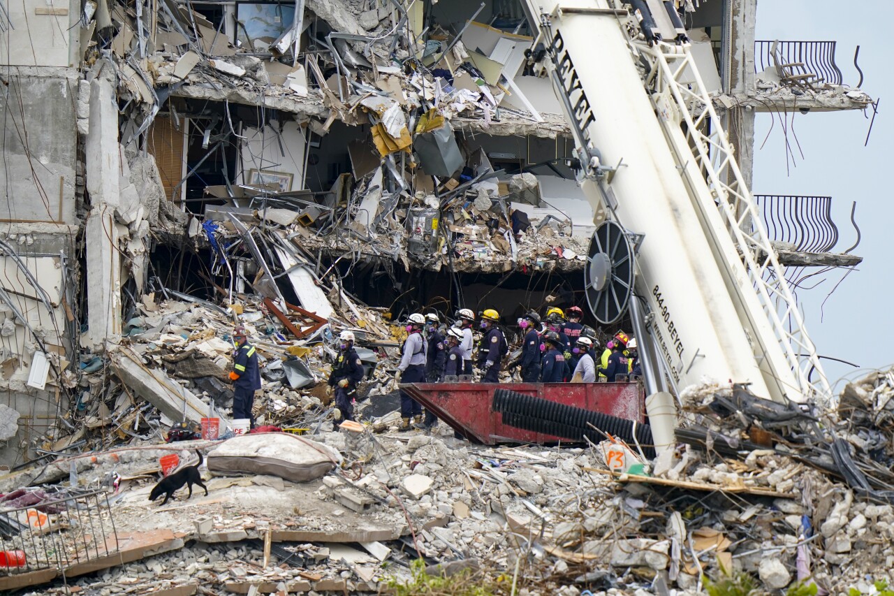 rescuers and dog search rubble of Champlain Towers South condo collapse, June 29, 2021