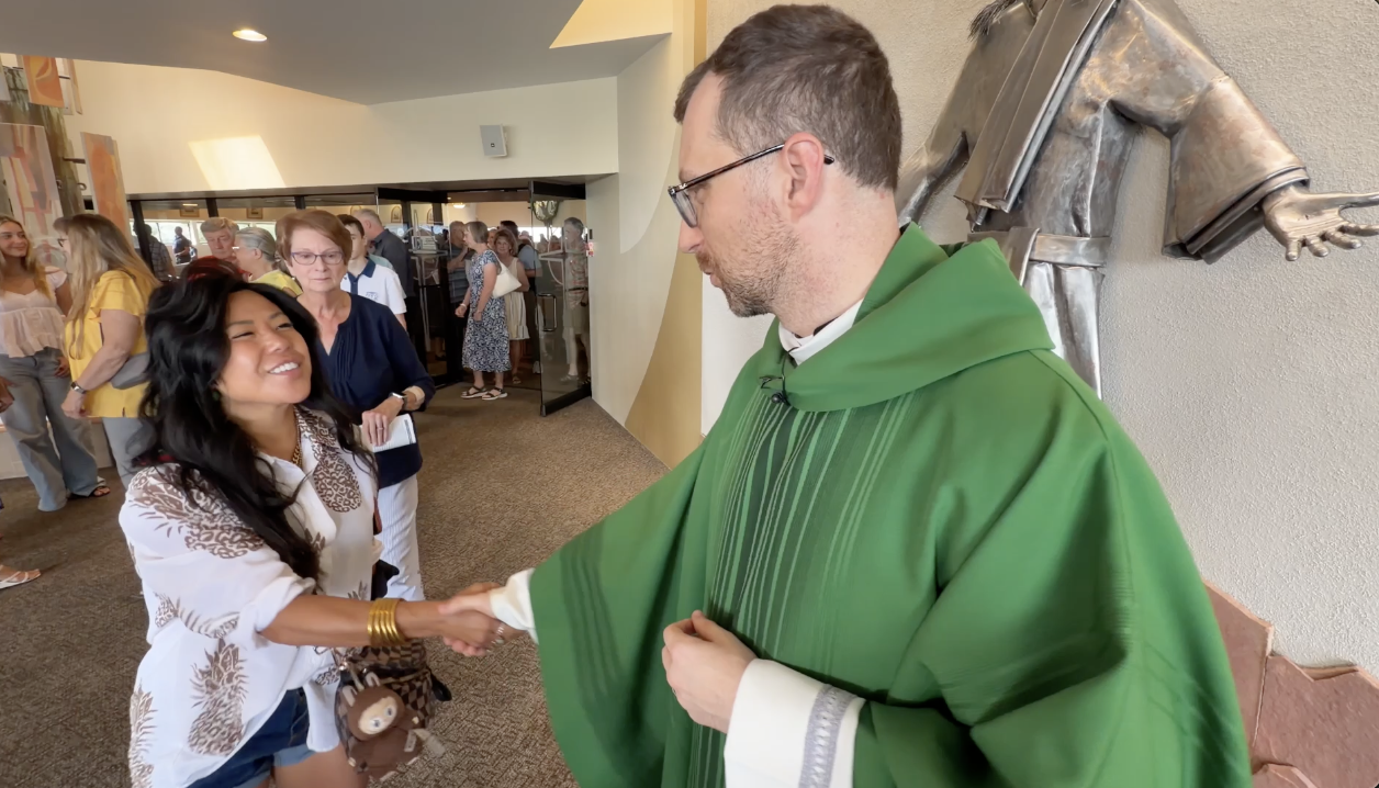 Father Witold meets parishioners after Sunday service