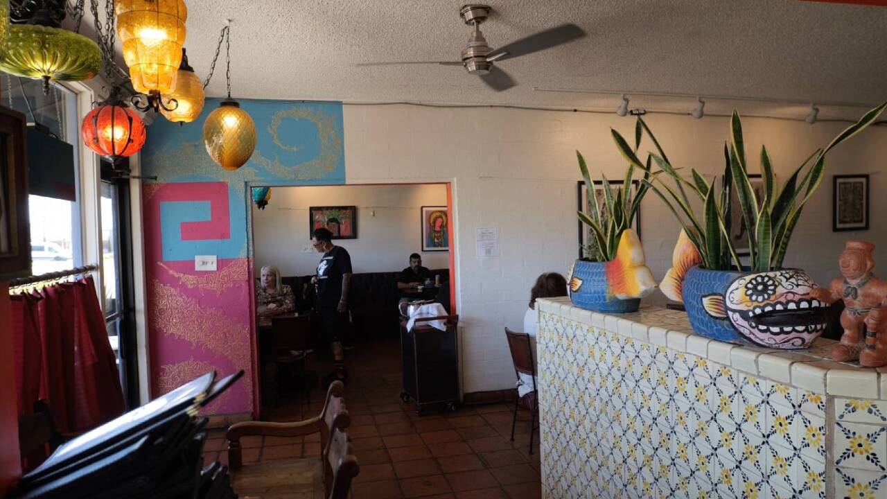 Esparza inside the restaurant she’s closing, talks with customers about their experience there.