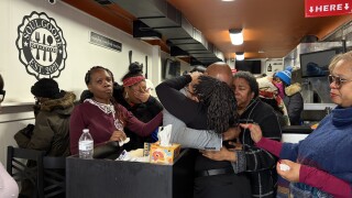 Friends and family comforting one another in the wake of Mucari Finley's death