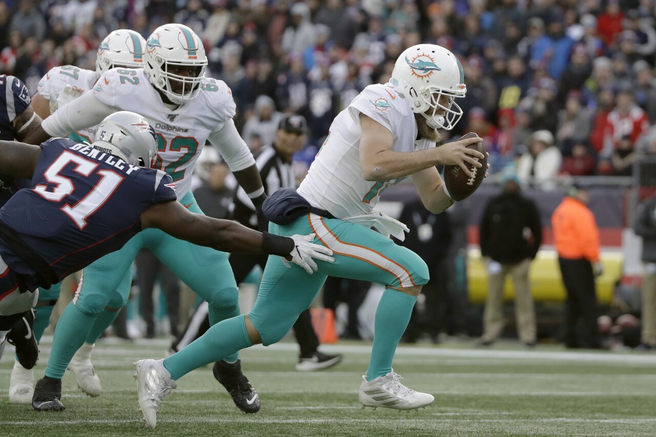 Miami Dolphins QB Ryan Fitzpatrick evades Ja'Whaun Bentley in December 2019