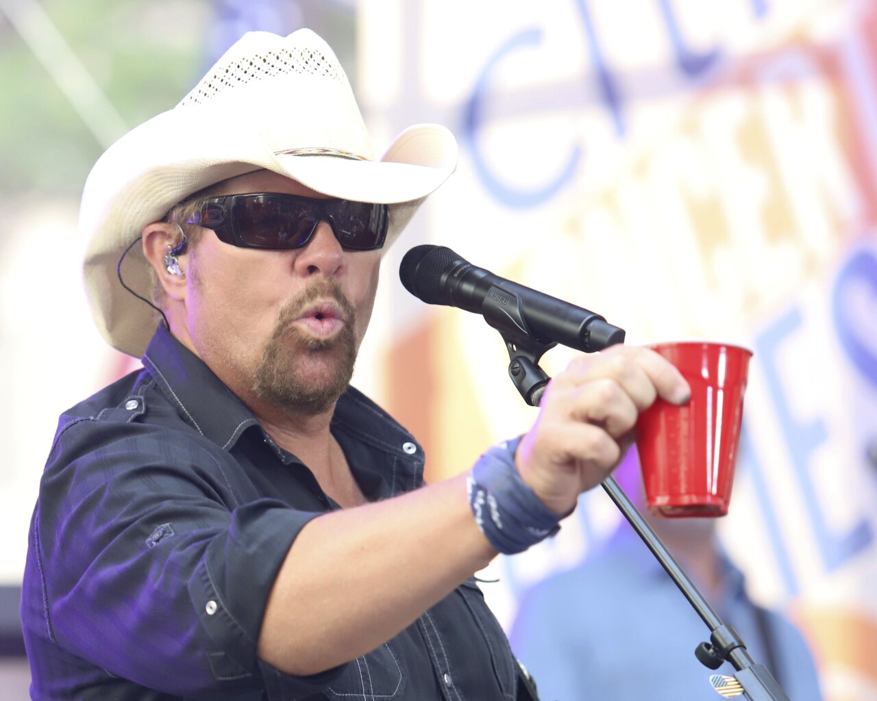 Toby Keith holds red Solo cup as he performs 'Red Solo Cup' in 2019