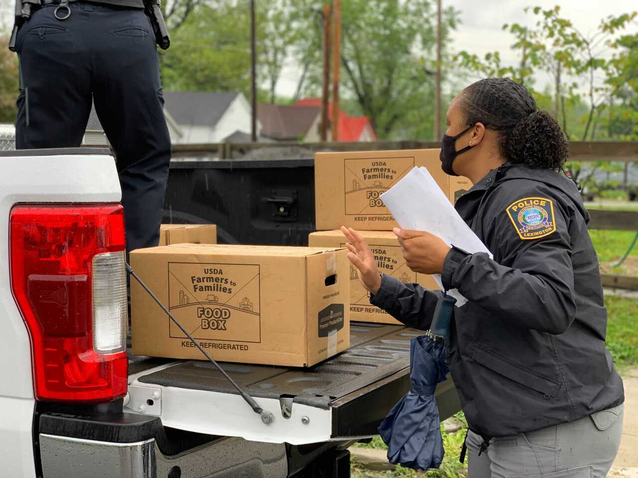 Police woman loading boxes.jpg