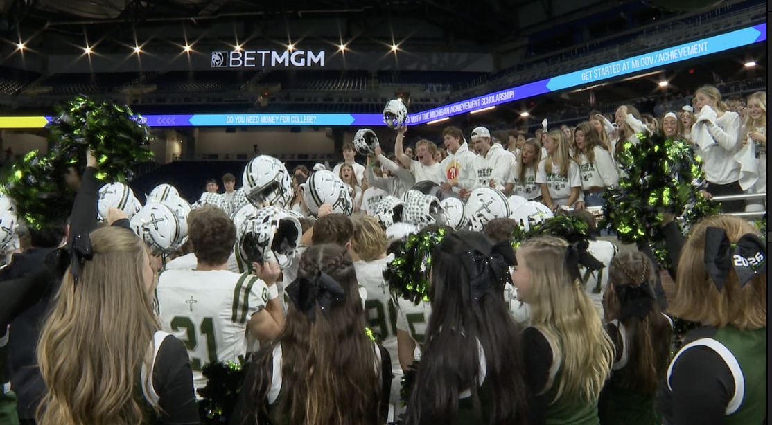 Team cheering with student section