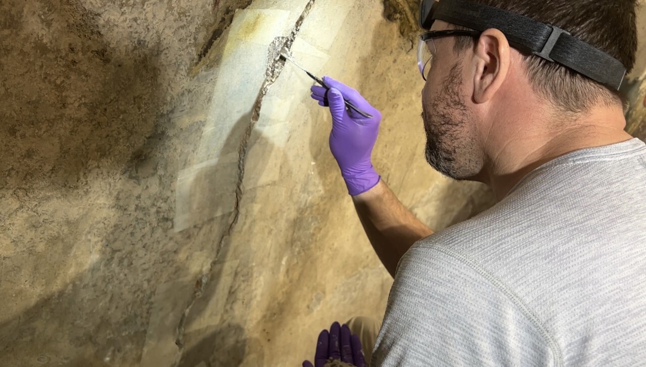 Conservation technician working on a crack in the main dome