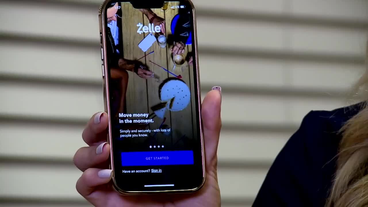 Jessica Bruno holds iPhone with Zelle on it