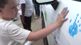 Child cancer patient putting hand on car