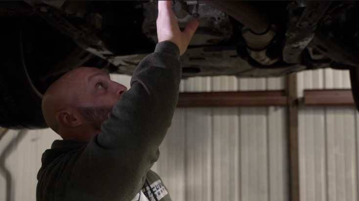 Steven Russo working on car