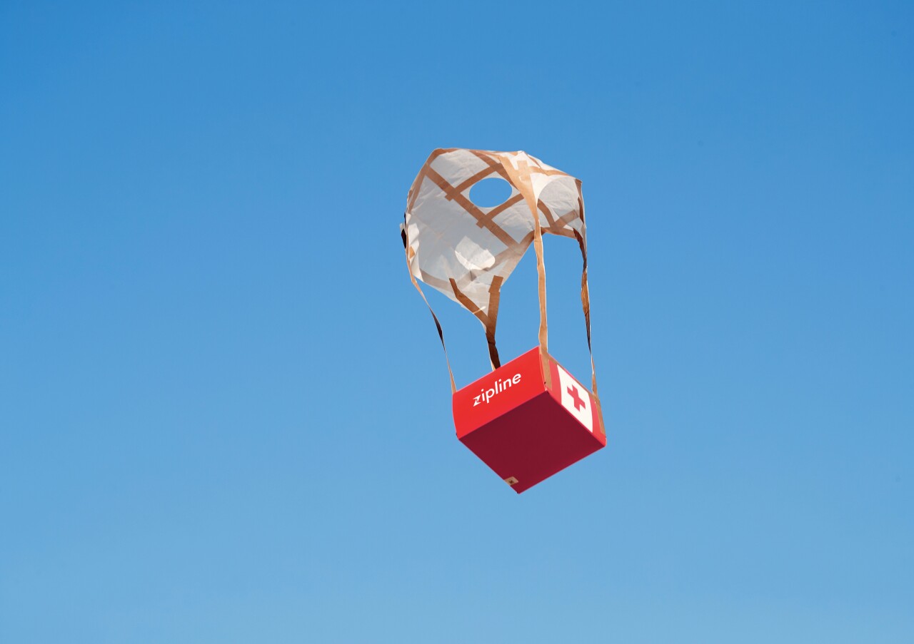Package with parachute being dropped in Rwanda from Zipline aircraft.jpg
