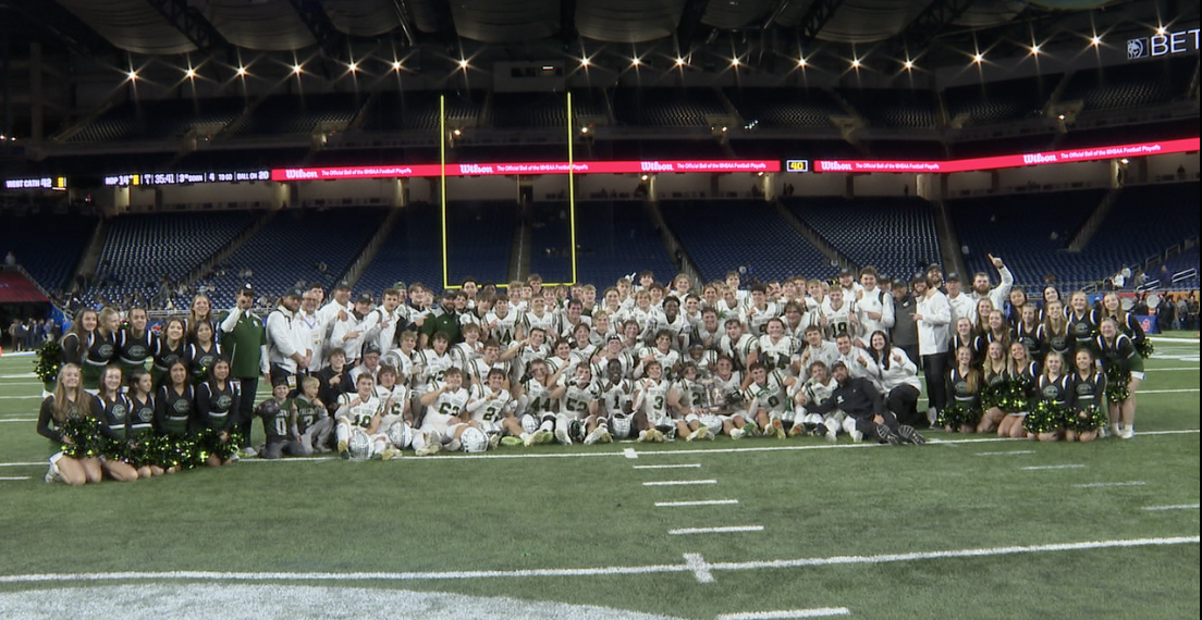Team taking photo with trophy
