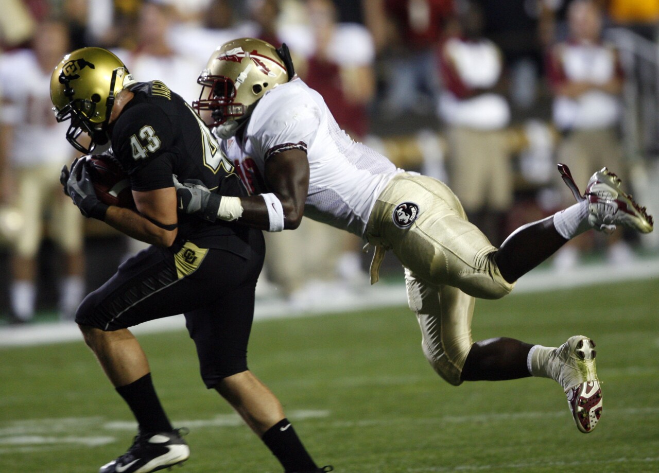 Florida State Seminoles linebacker Geno Hayes tackles Colorado Buffaloes fullback Samson Jagoras in 2007