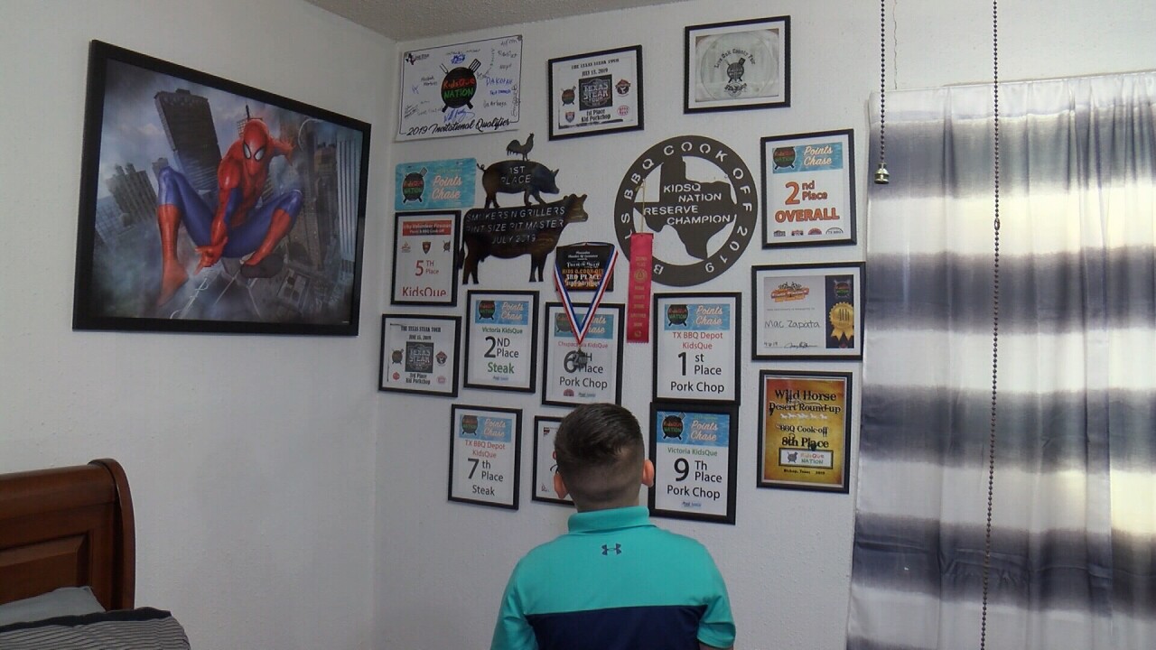 MAC ZAPATA WITH AWARDS.jpg