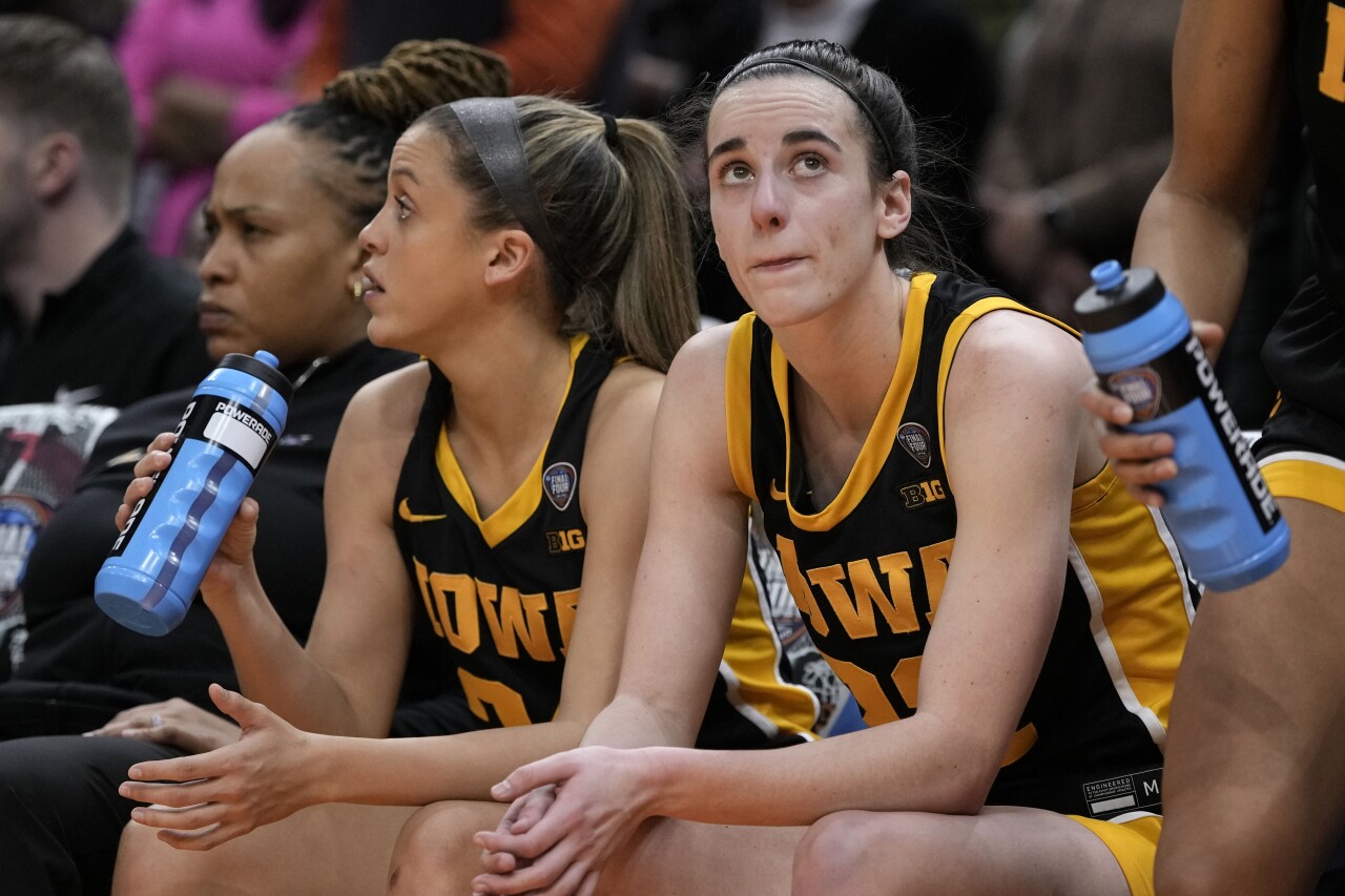 Iowa Hawkeyes guard Caitlin Clark sits on bench at end of national championship game, April 7, 2024