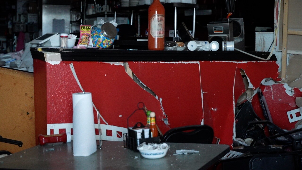 Smashed-in wall by the kitchen of Sweet's Diner.