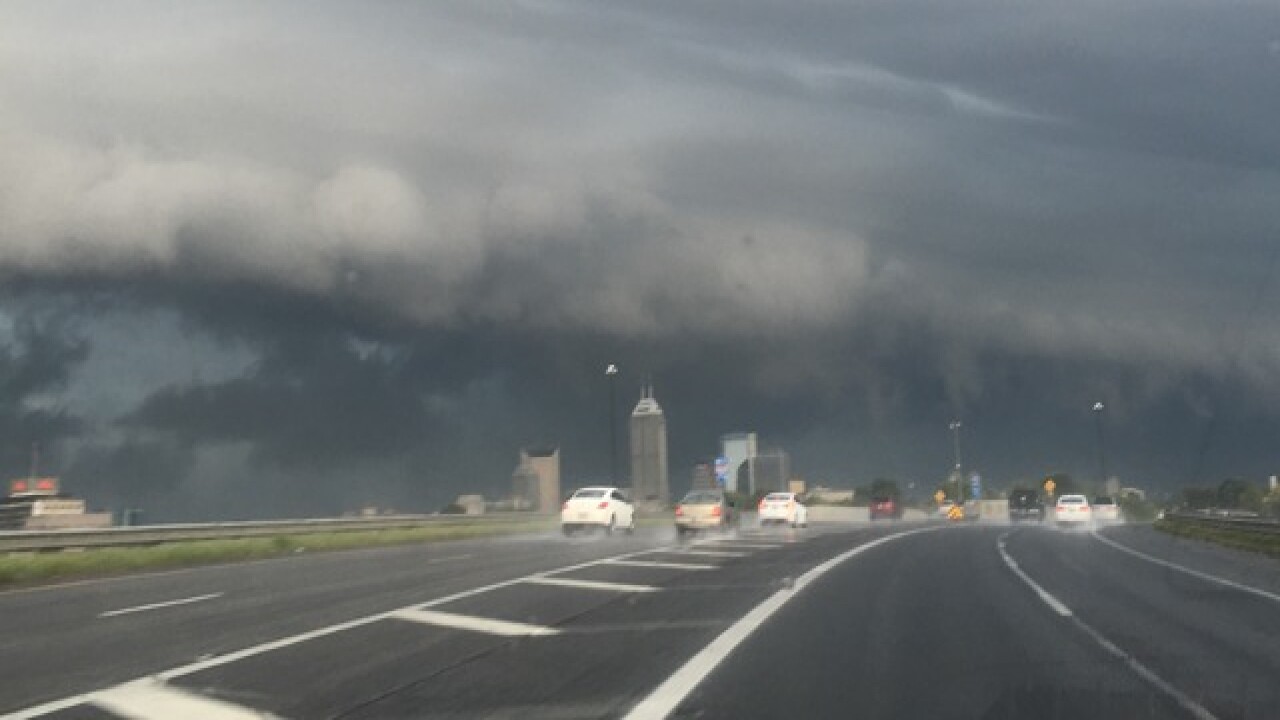 PHOTOS: Ominous clouds, downed trees, flooding