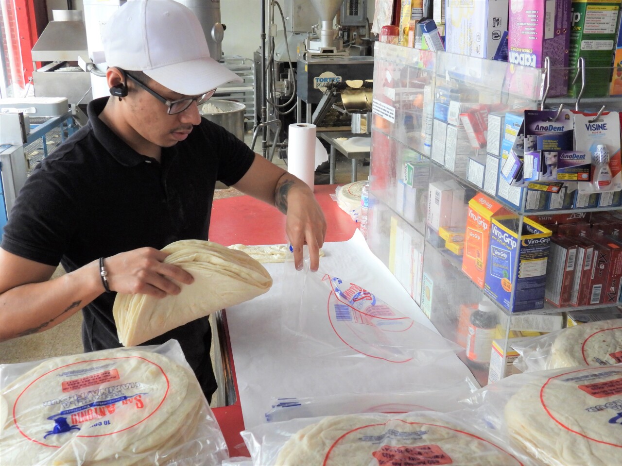 An employee packages freshly-made tortillas at San Antonio.jpg