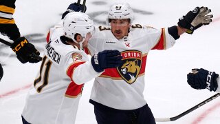 Florida Panthers left wing Brad Marchand, right, celebrates after a goal by right wing Mackie Samoskevich (11) during the first period of an NHL hockey game, Tuesday, Oct. 21, 2025, in Boston.