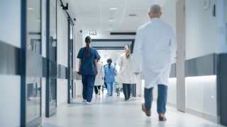 Hospital,Hallway,With,Doctors,,Nurses,And,Specialists,In,Hospital.,Female
