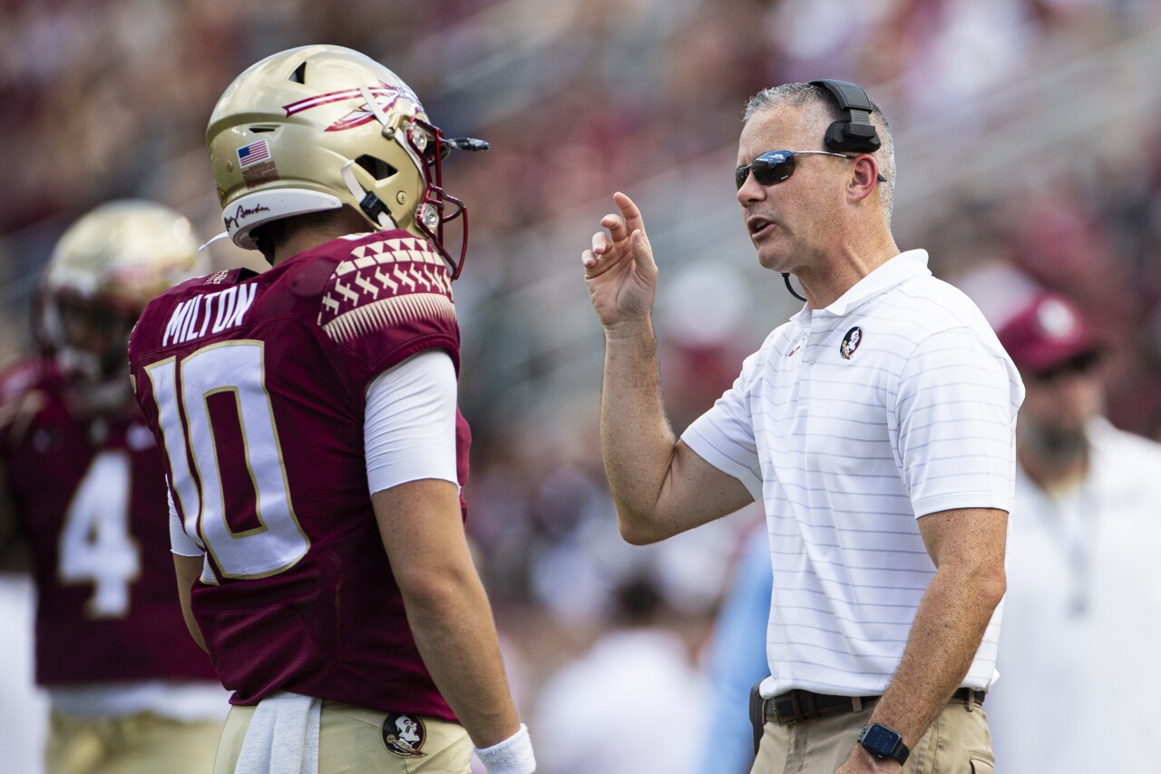Florida State Seminoles head coach Mike Norvell speaks to QB McKenzie Milton on sideline vs. Louisville Cardinals in 2021
