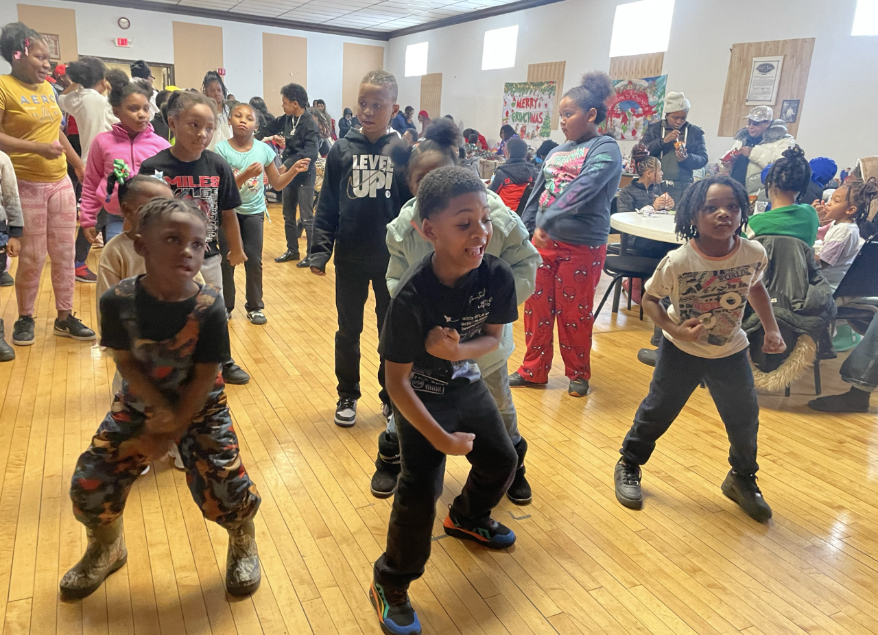 KID DANCING AT THE TOY GIVEAWAY