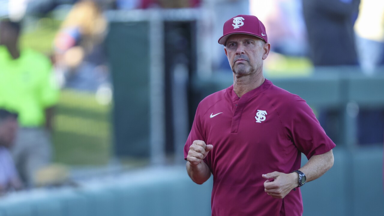 Florida State Seminoles baseball coach Link Jarrett jogs to dugout at Florida Gators, March 12, 2024