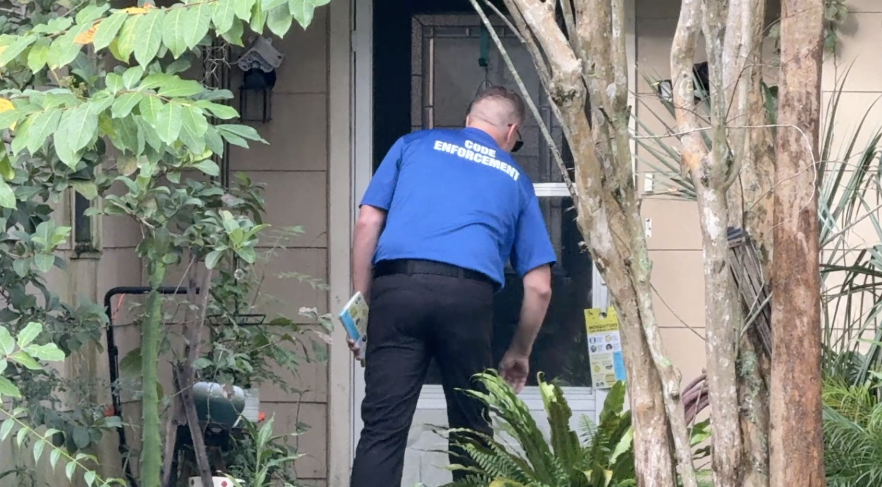 Code Enforcement leaving a pamphlet