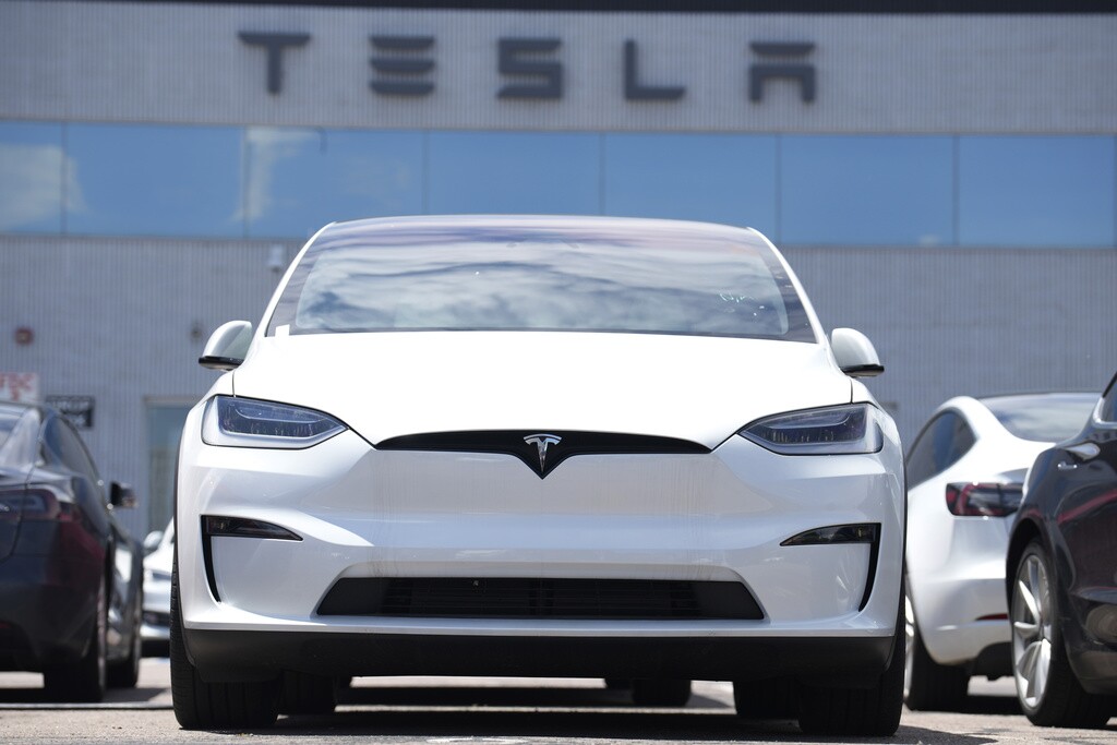 A 2023 Model X sits outside a Tesla dealership.