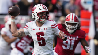 Wisconsin quarterback Carter Smith throws during the first half of an NCAA college football game against Indiana, Saturday, Nov. 15, 2025, in Bloomington, Ind.