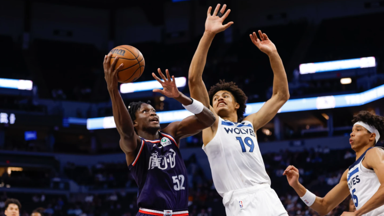 Guangzhou Loong-Lions guard Victor Oladipo (52) goes up to shoot while Minnesota Timberwolves center Joan Beringer (19) defends during the first half of a preseason NBA basketball game Monday, Oct. 13, 2025, in Minneapolis, Minn.