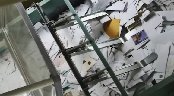 USPS Mail is sorted though a series of conveyer belts and scanners.png